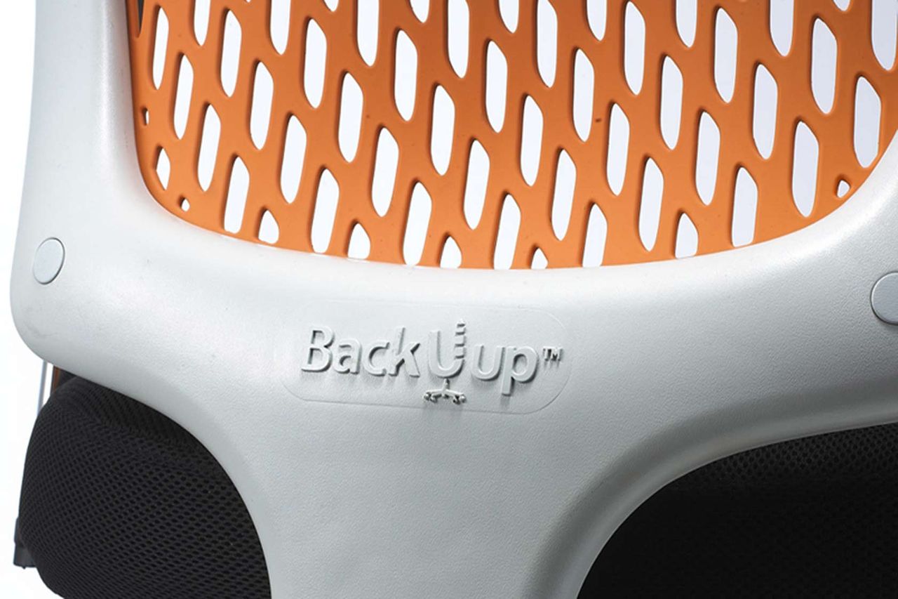 Close-up of the patented BackUup flexing backrest in orange mesh